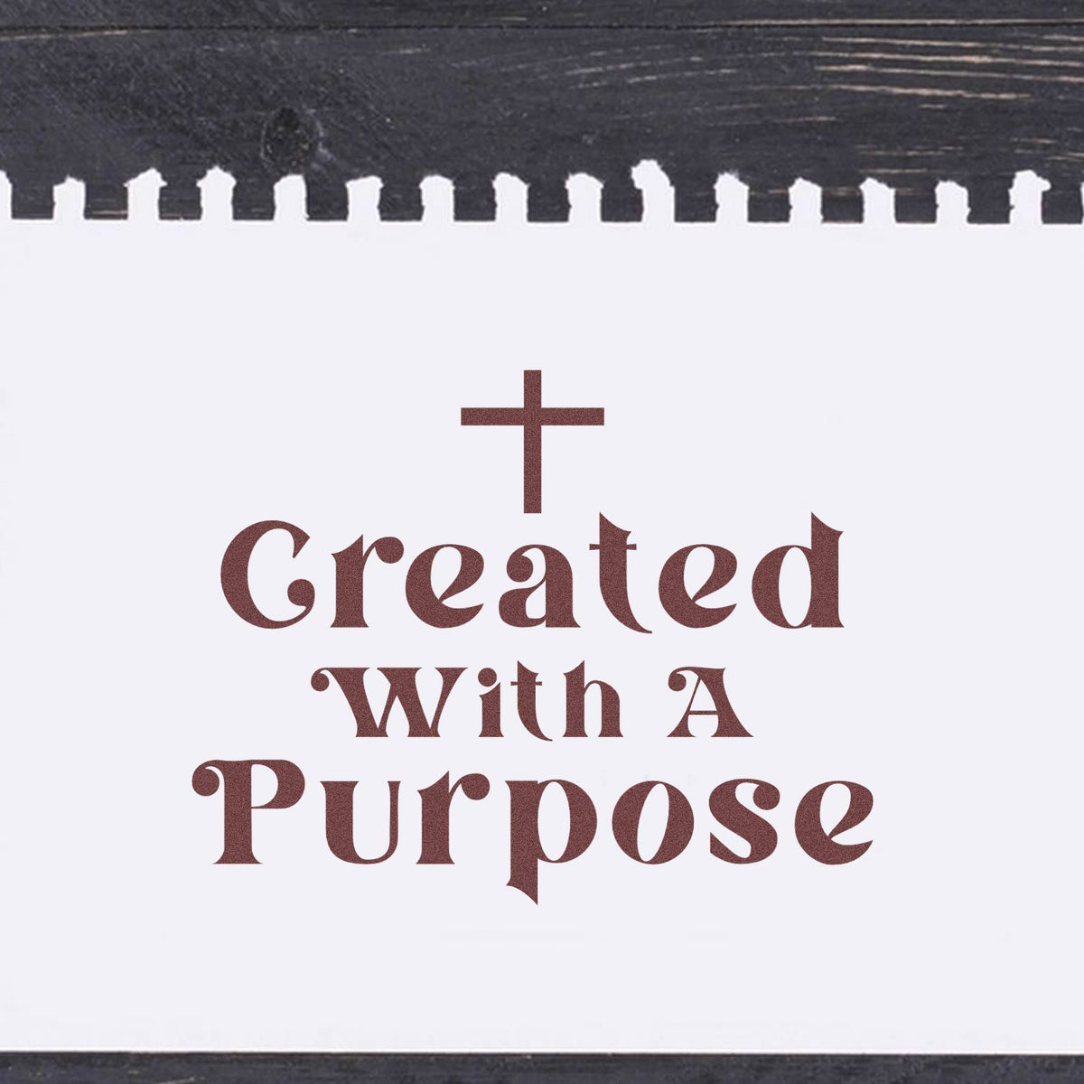 Brown church stamp and seal reading Created With A Purpose with a cross on white paper and a black torn-edge border.