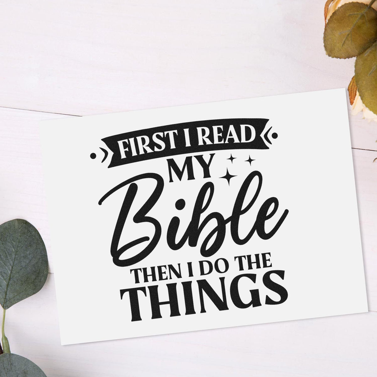 Black rubber stamp seal reading First I Read My Bible Then I Do the Things on white card with green leaves.