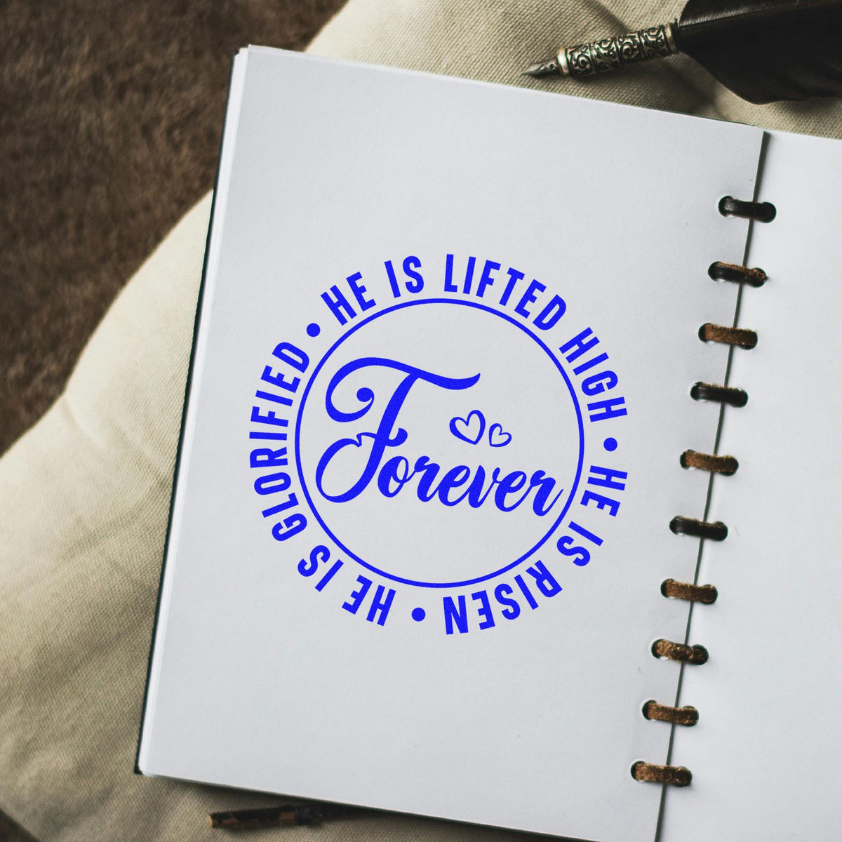 Blue circular stamp seal reading Forever on a white notebook page with spiral binding and pen