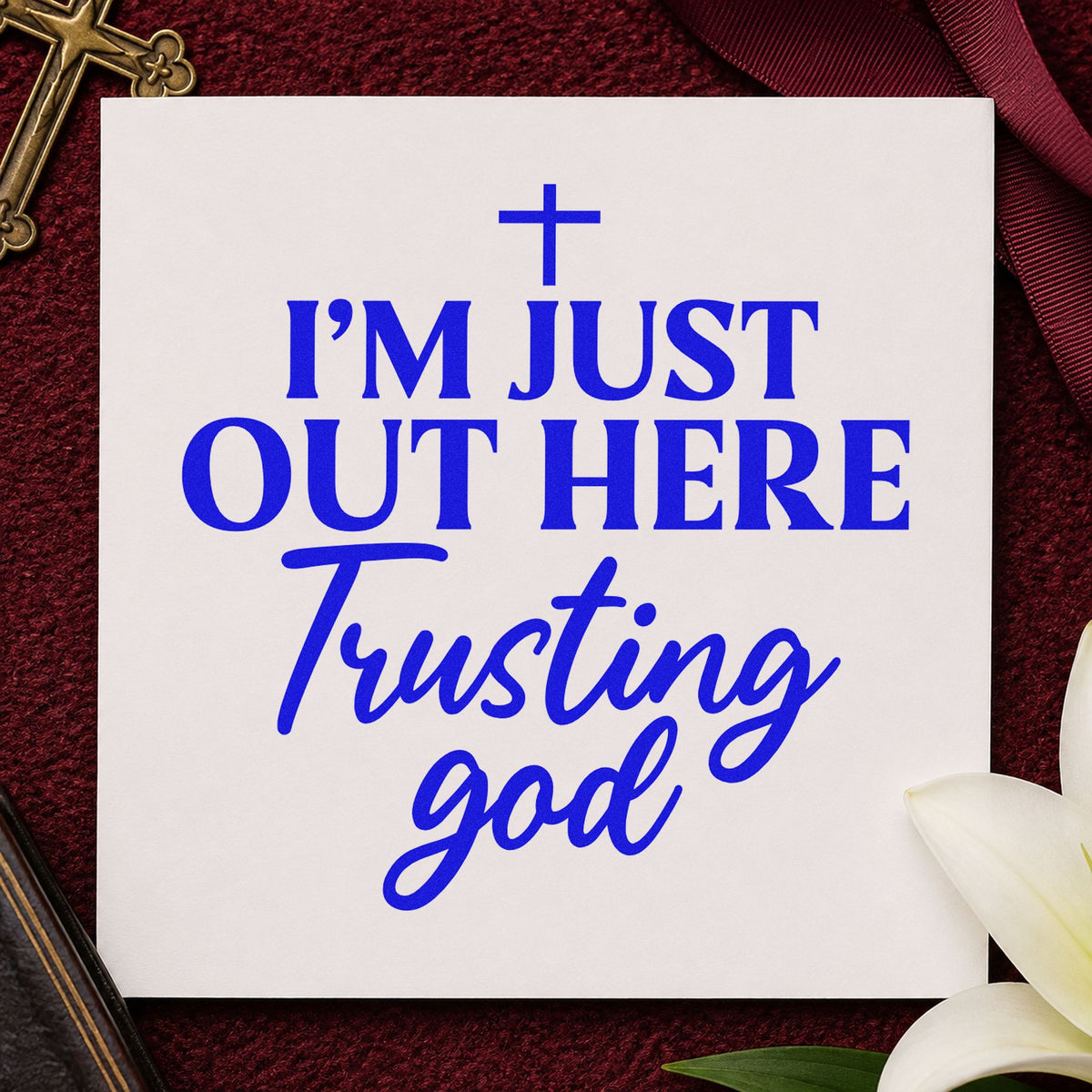 Out Here Trusting God craft stamp imprinted in blue ink on paper, a design suited to tea towel gifts.