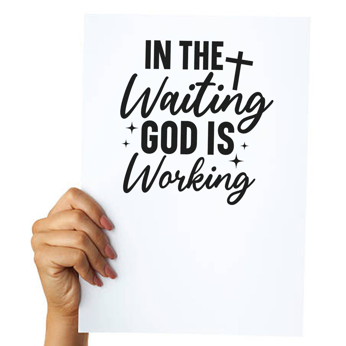 Hand holding white stamp/seal design with black script text In the waiting God is working, plus cross and sparkles.