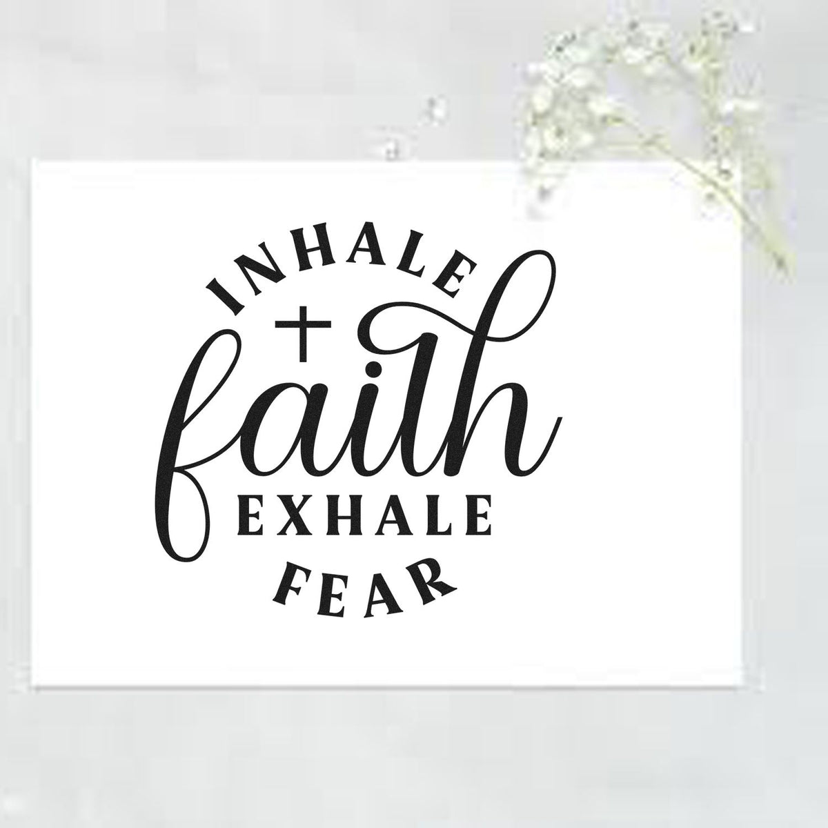 Black Inhale Faith, Exhale Fear stamp seal design with cross on a white square card, minimalist black lettering.