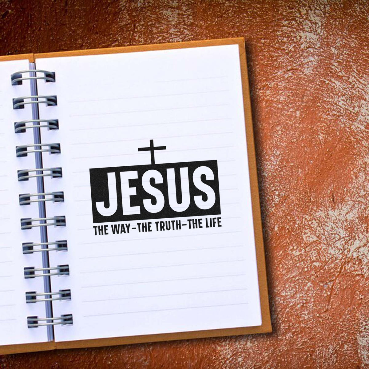 Black JESUS cross stamp/seal on white lined notebook page, with The Way, the Truth, the Life tagline.
