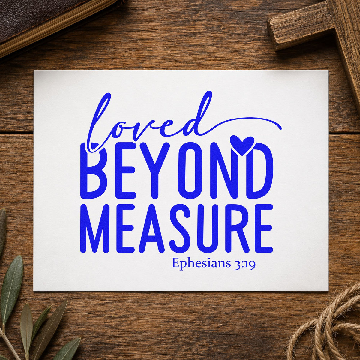 Loved Beyond Measure craft stamp in blue ink on cardstock, an easy option for onesie stamping.