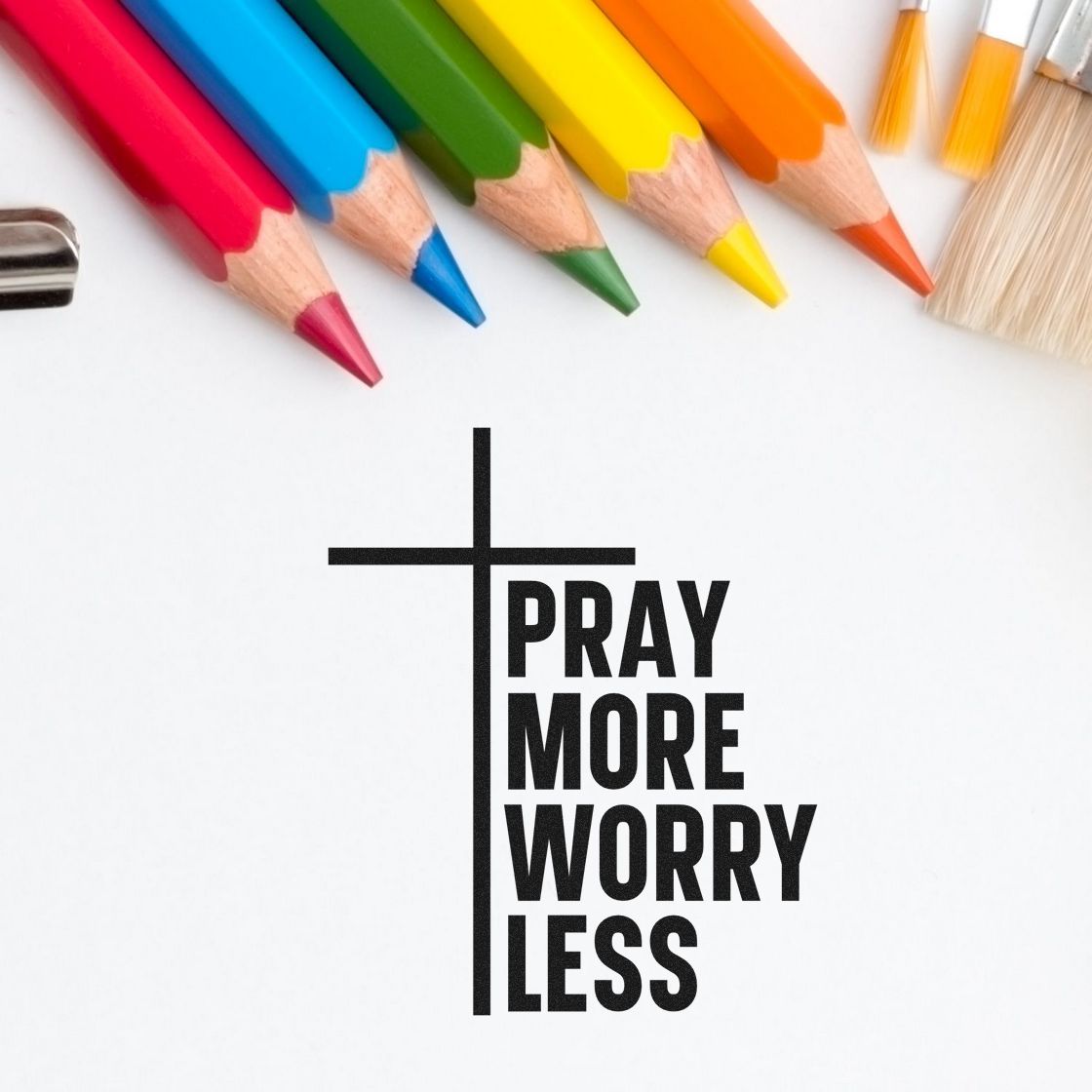 Black Christian stamp and seal design with cross and Pray More Worry Less text, framed by colorful pencils on white.