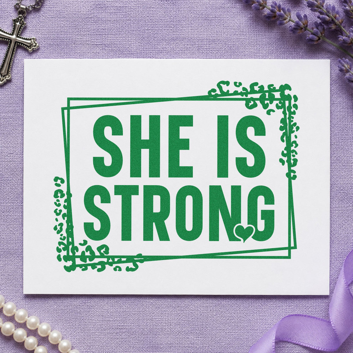 She Is Strong craft stamp imprint in green ink on a handmade project, one idea being survivor celebrations.