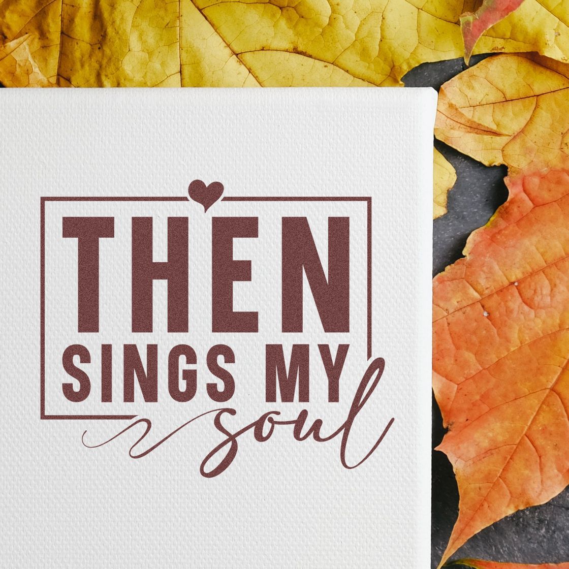 Burgundy stamp seal on white textured card reading Then sings my soul, framed by a heart and autumn leaves.