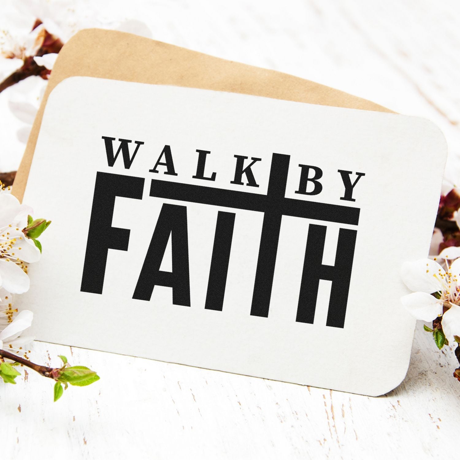 White rounded stamp seal card with bold black WALK BY FAITH text, tan backing, and white blossoms.