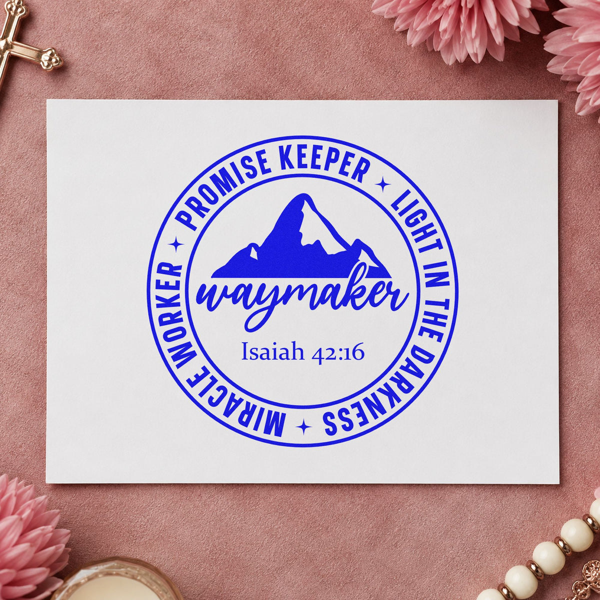 Waymaker Mountain Badge craft stamp imprinted in blue ink on paper, a design suited to coasters.