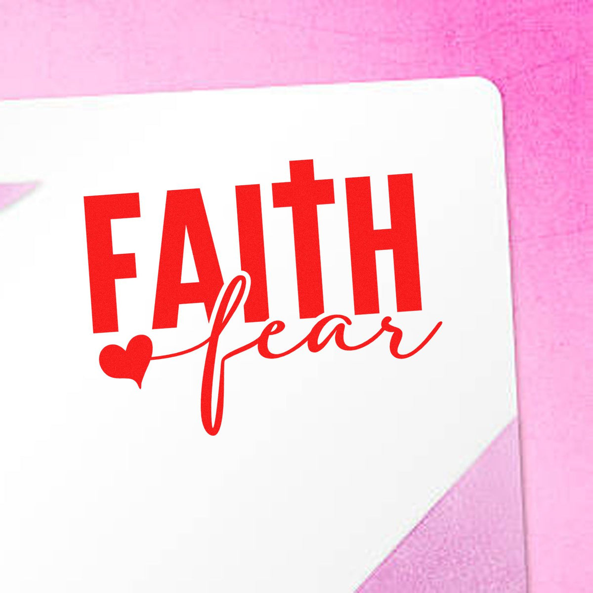 Red FAITH Love stamp seal with heart on white envelope against a pink background