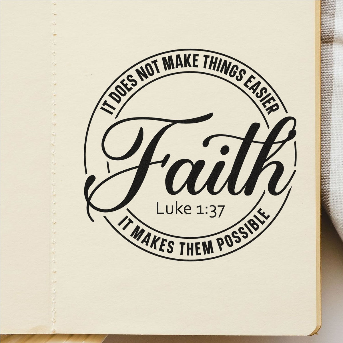 Black circular faith stamp seal on cream paper, with Luke 1:37 and It does not make things easier, it makes them possible.