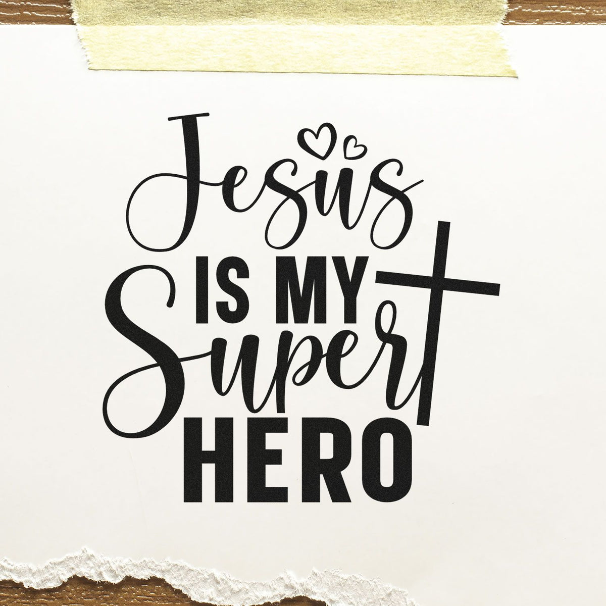Black Jesus Is My Super Hero stamp/seal design with hearts on white paper, taped at top and torn at bottom.