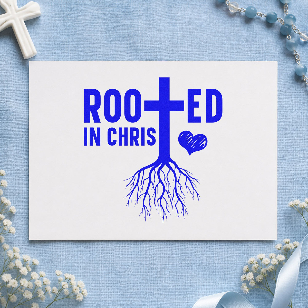 Rooted in Christ craft stamp imprinted in blue ink on paper, a design suited to baptism gifts.