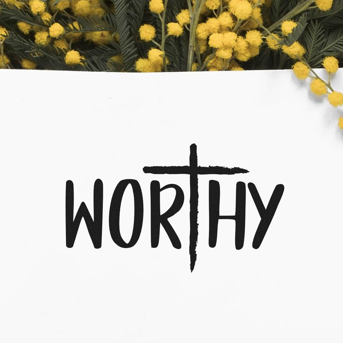 Black WORTHY stamp and seal on white card, framed by yellow flowers and dark green foliage.