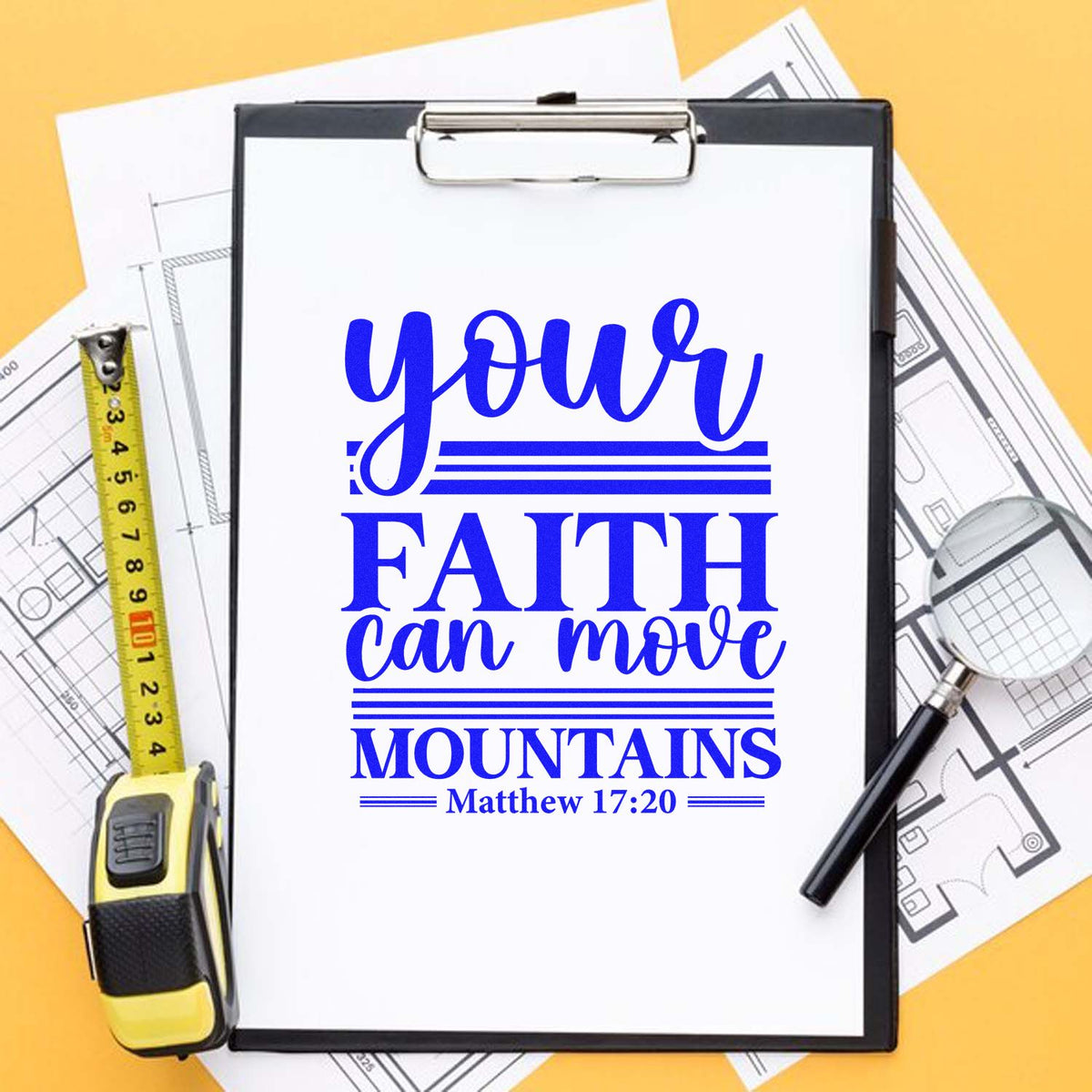 Blue custom stamp seal design reading Your faith can move mountains with Matthew 17:20, on clipboard with plans.