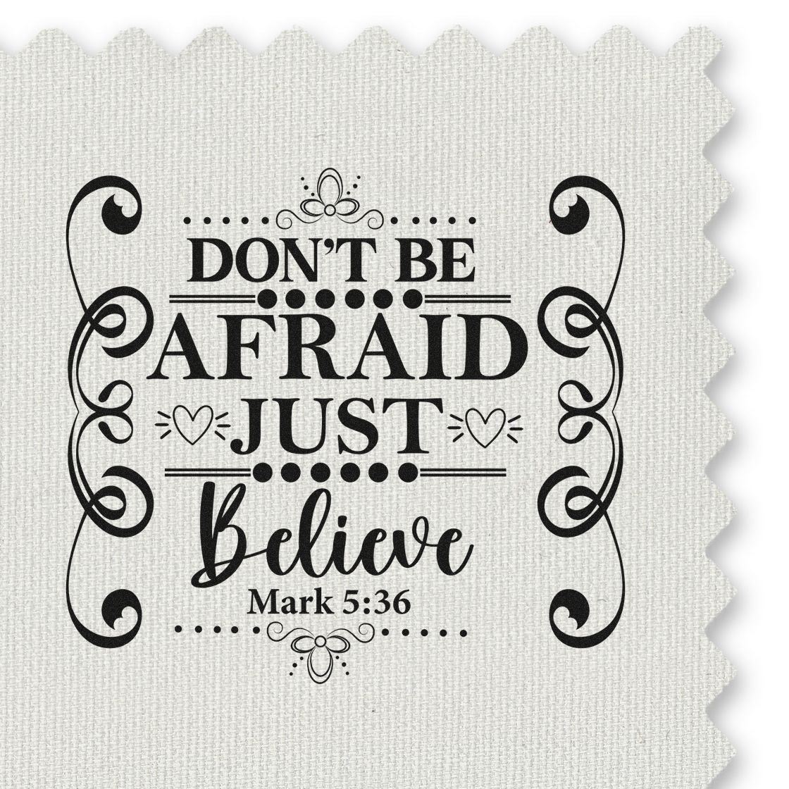 Black decorative Christian stamp/seal on white textured fabric, reading Dont be afraid, just believe with swirls and Mark 5:36.