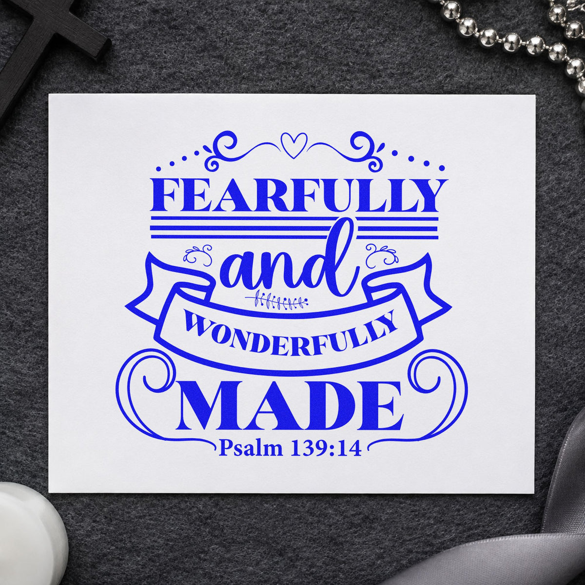 Fearfully Wonderfully Made Ribbon craft stamp in blue ink on cardstock, an easy option for onesie stamping.
