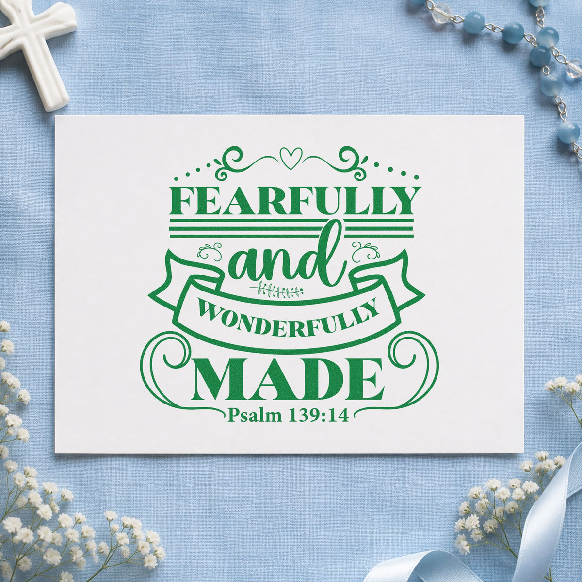 Fearfully Wonderfully Made Ribbon craft stamp imprint in green ink on a handmade project, one idea being framed nursery art.