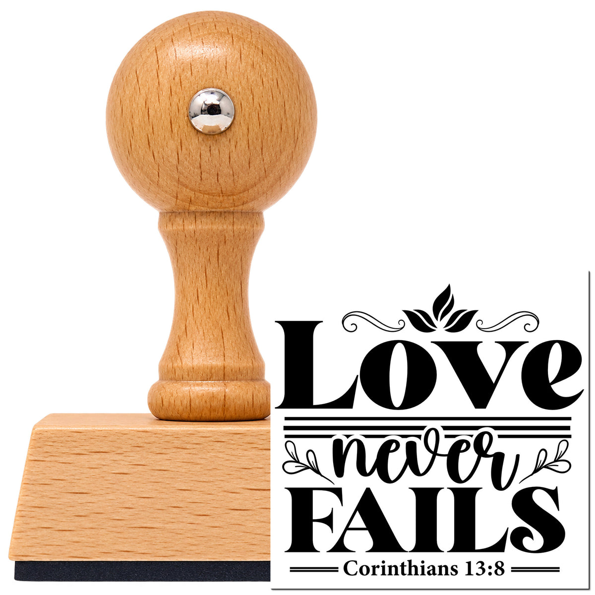 Vintage Pro beech wood stamp with a round knob handle, shown with its black Love Never Fails Flourishes imprint on white.