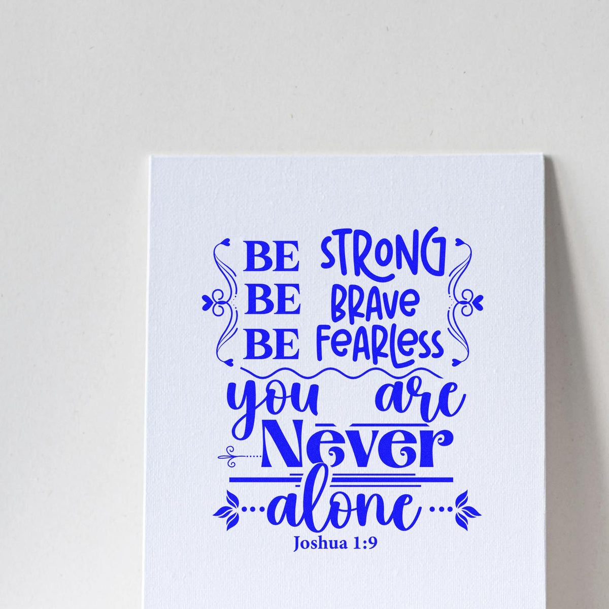 Blue stamp and seal imprint on white paper with Be strong, be brave, be fearless, you are never alone and Joshua 1:9.