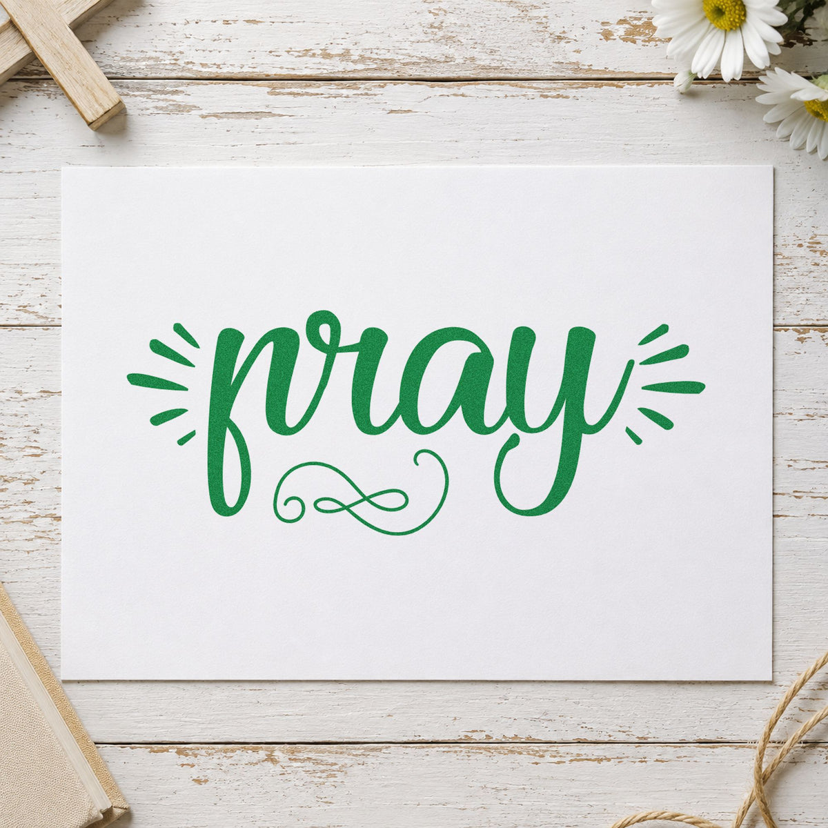 Pray Radiating Script craft stamp imprint in green ink on a handmade project, one idea being envelope seals.