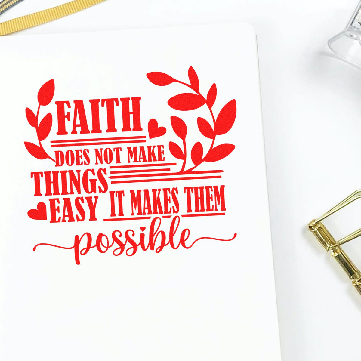 Red faith quote stamp and seal design with leafy hearts on white paper, featuring gold binding accents.