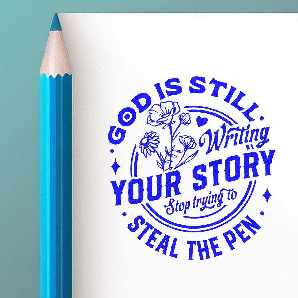 Blue rubber stamp seal on white paper beside a blue pencil, featuring floral design and Good Is Still Your Story text.