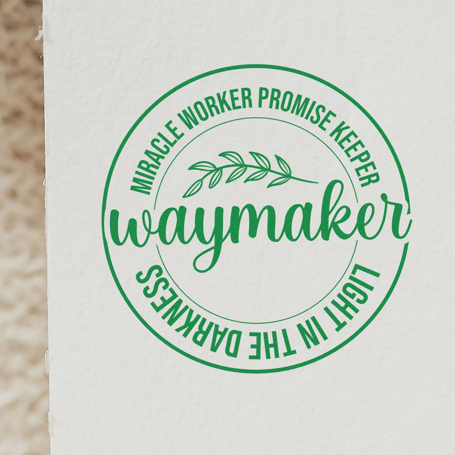 Green circular stamp seal with waymaker and Miracle Worker Promise Keeper, Light in the Darkness on white paper.