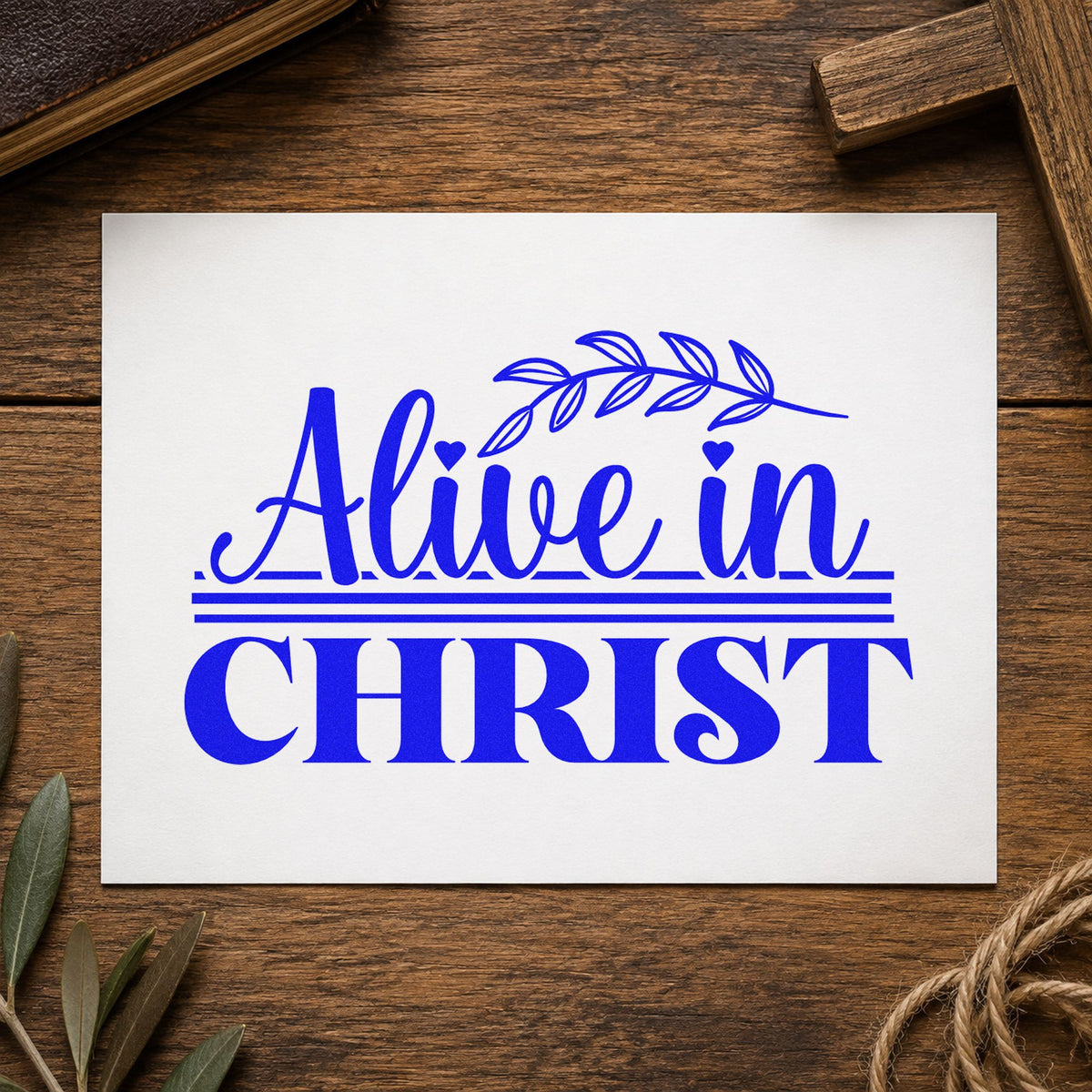 Alive in Christ craft stamp imprinted in blue ink on paper, a design suited to recovery milestones.