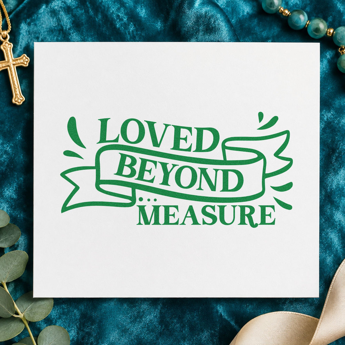 Loved Beyond Measure Ribbon craft stamp imprint in green ink on a handmade project, one idea being measuring tape gifts.