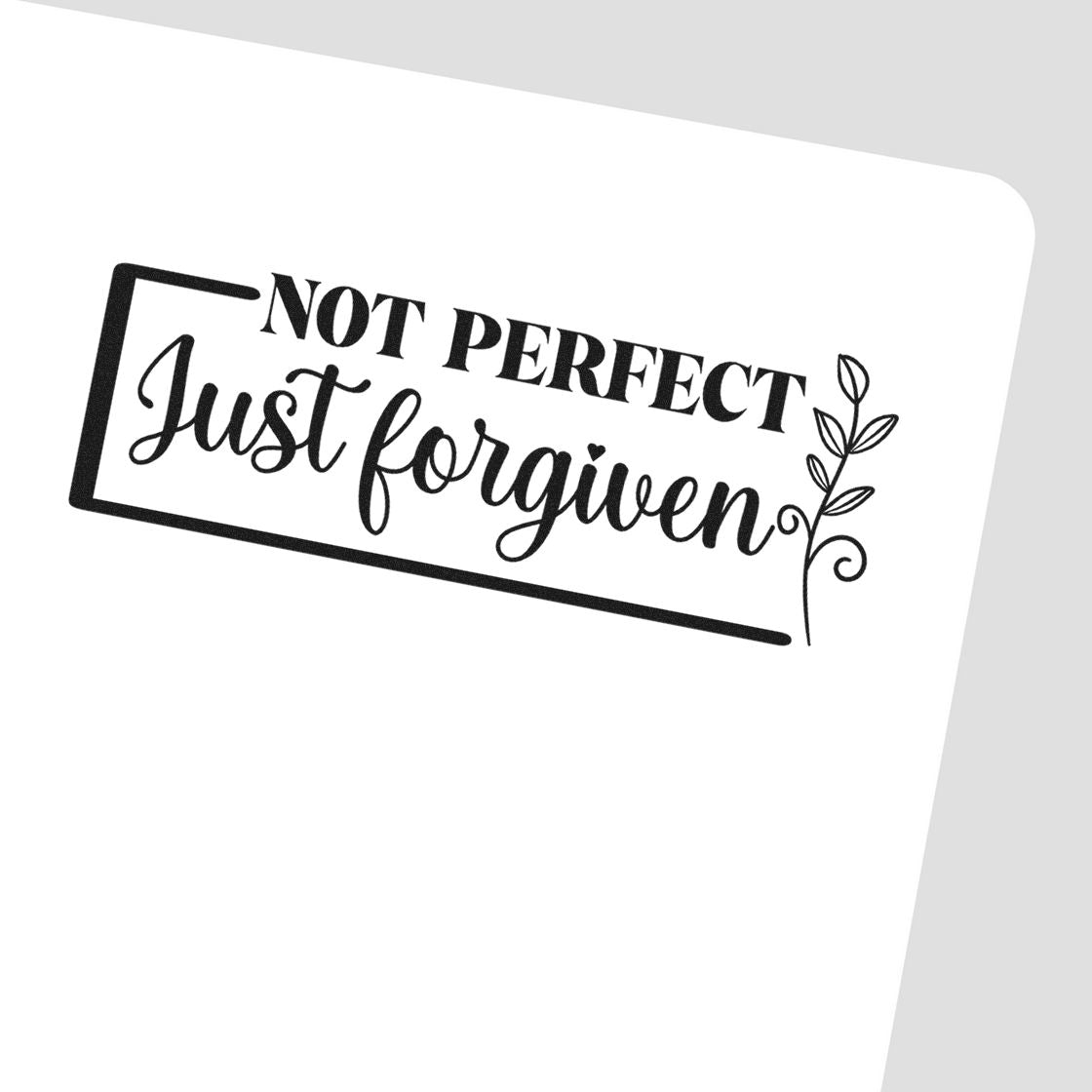 Black stamp design reading Not Perfect Just Forgiven with leaf accent, on a white background.