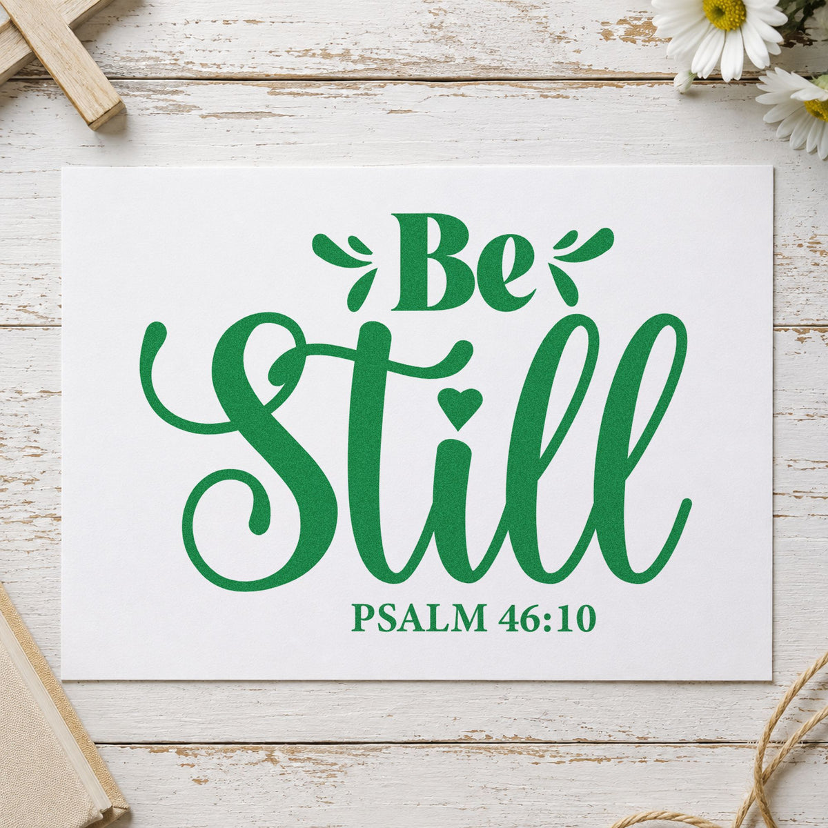 Be Still craft stamp imprint in green ink on a handmade project, one idea being framed bedroom art.