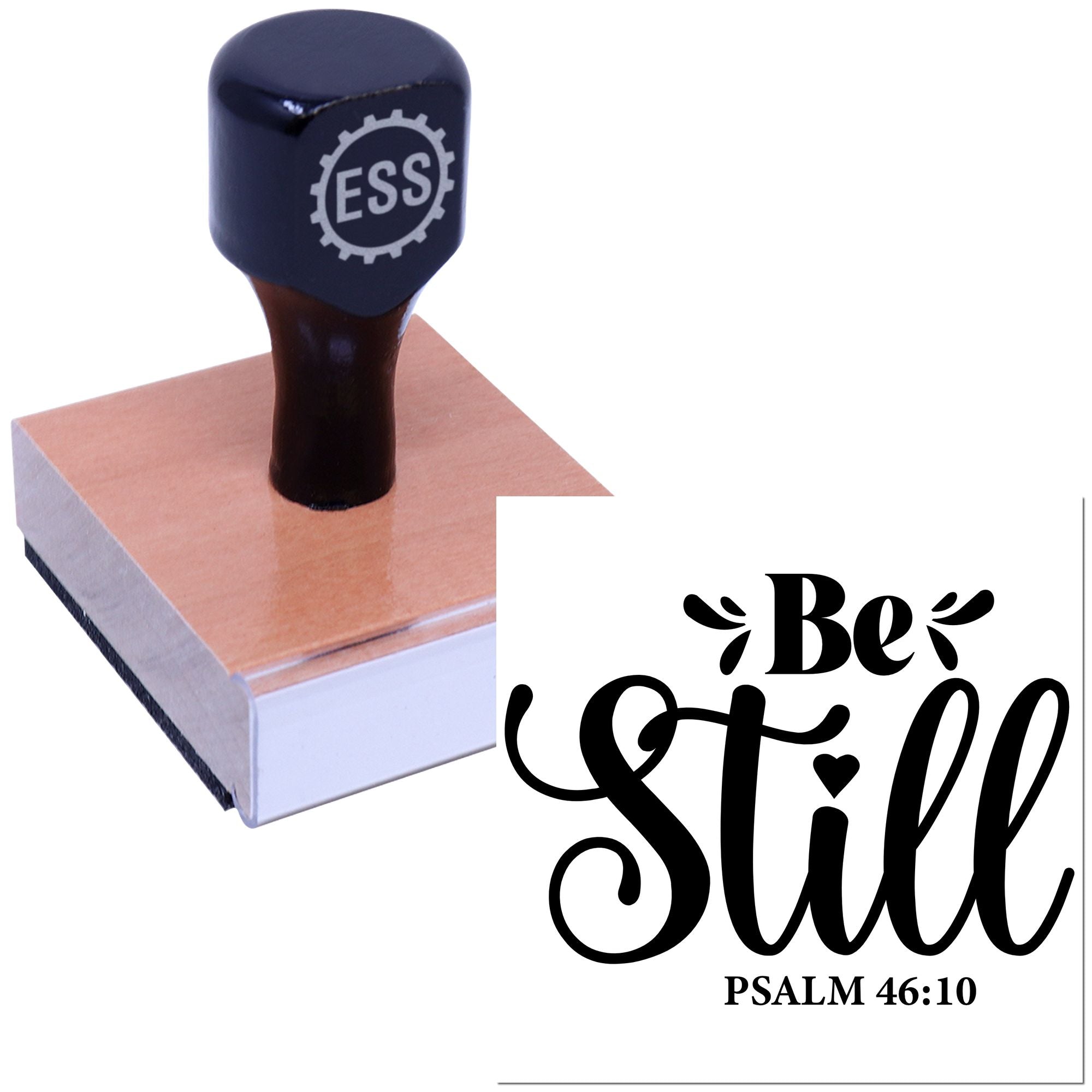Black custom rubber stamp with ESS logo on a wooden block, beside a white seal design reading Be Still in black script.