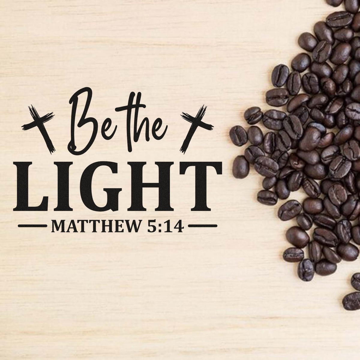 Christian stamp and seal design with Be the Light Matthew 5:14 in black on light wood, framed by dark coffee beans.