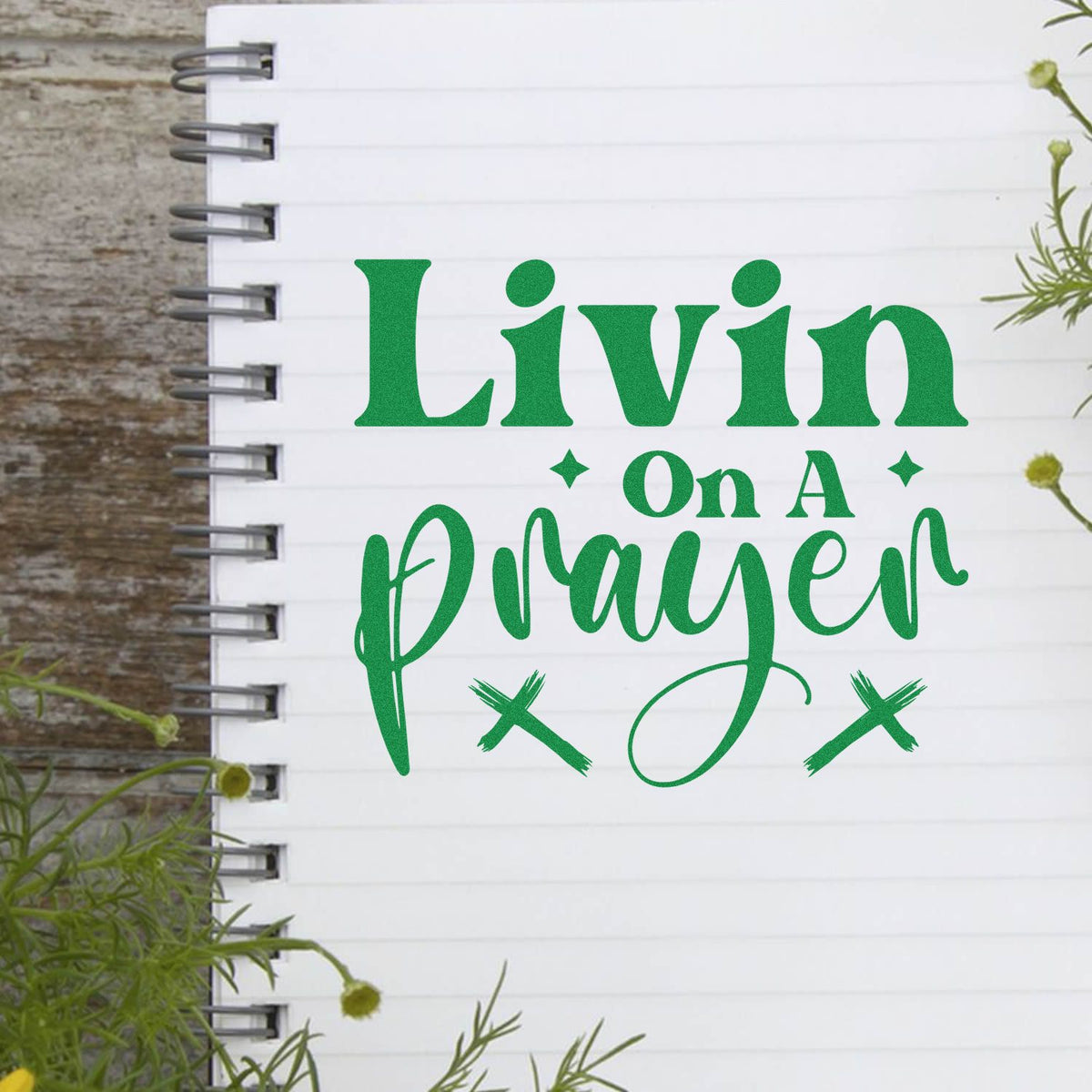 Green custom stamp and seal reading Livin on a Prayer on a white spiral notebook page, with stars and script lettering.