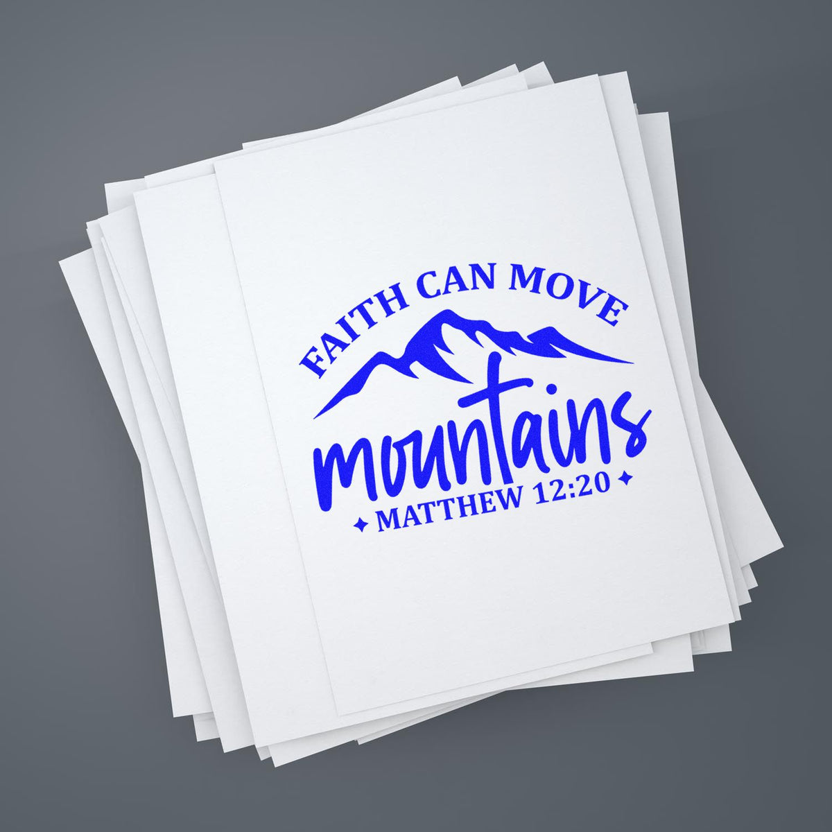 Blue faith-based stamp seal reading Faith Can Move Mountains, Matthew 12:20 on stacked white paper.