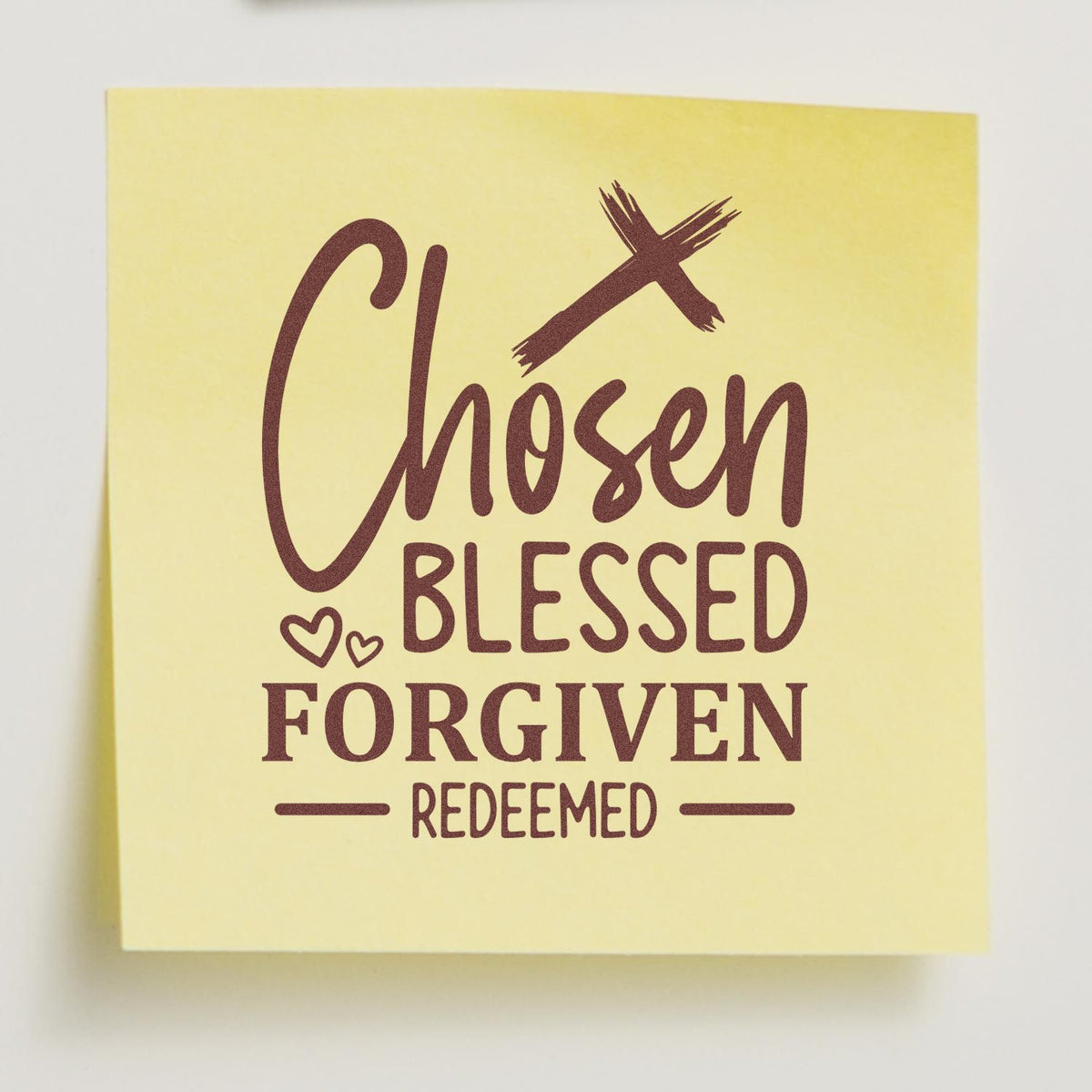 Yellow custom rubber stamp with maroon Chosen, Blessed, Forgiven, Redeemed lettering and small heart accents.