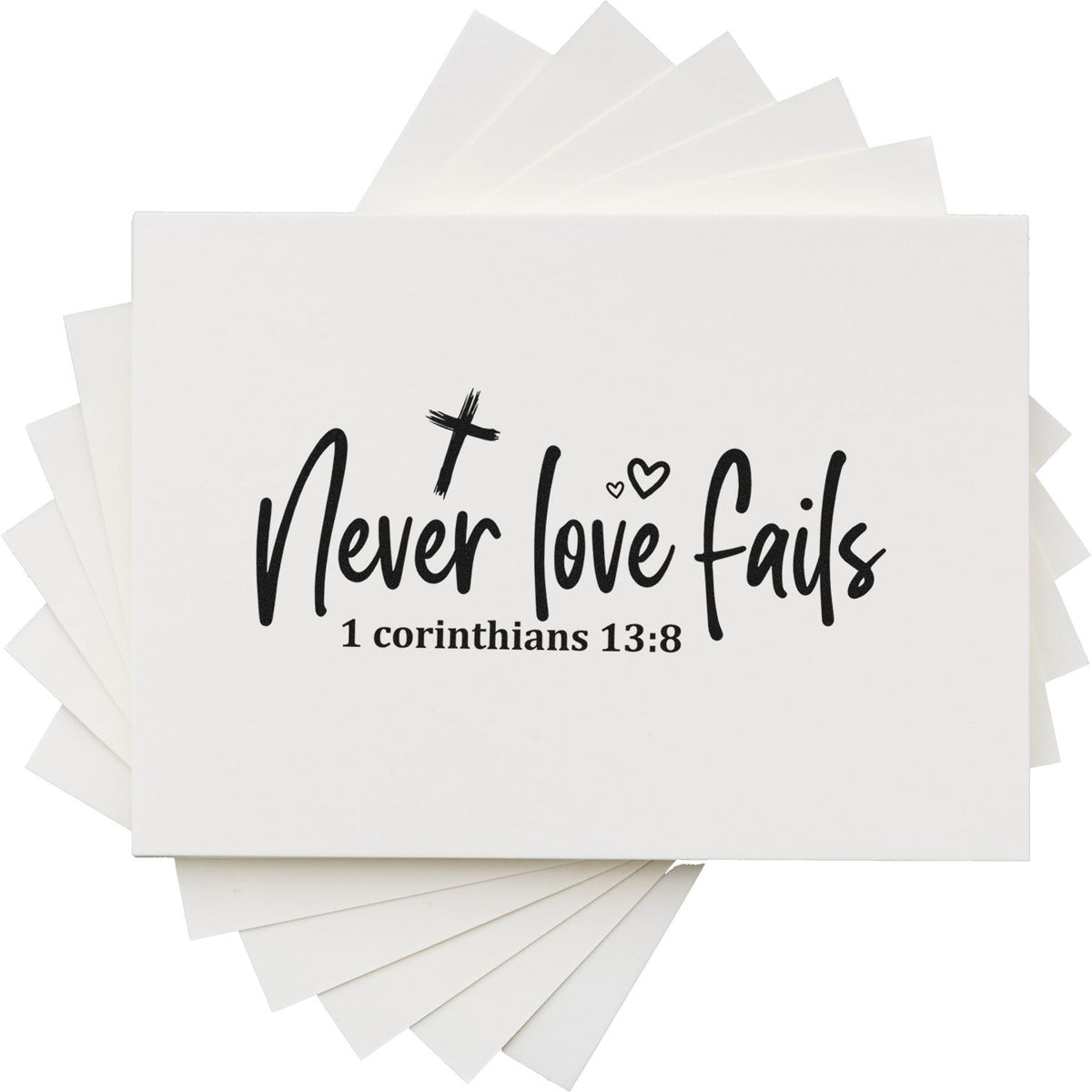 White stamp and seal cards with black Never love fails scripture text, small hearts, and layered white paper edges.