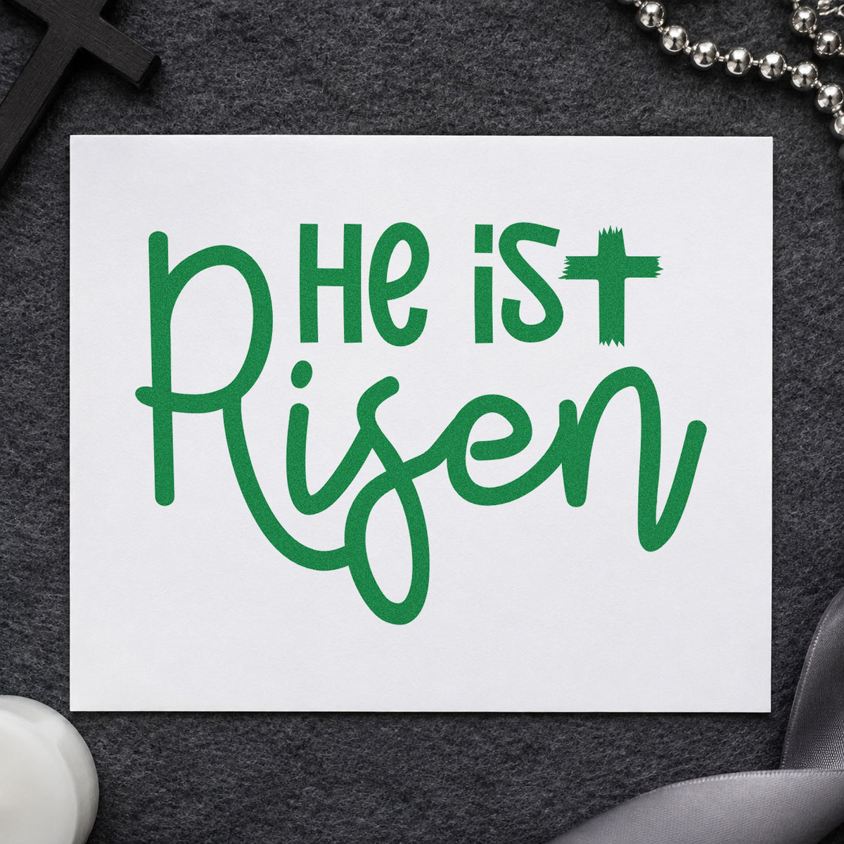 He Is Risen Script craft stamp imprint in green ink on a handmade project, one idea being framed spring art.