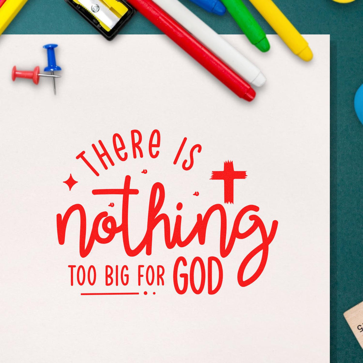 Red stamp/seal reading There is nothing too big for God on white paper, with colorful markers and pushpins.