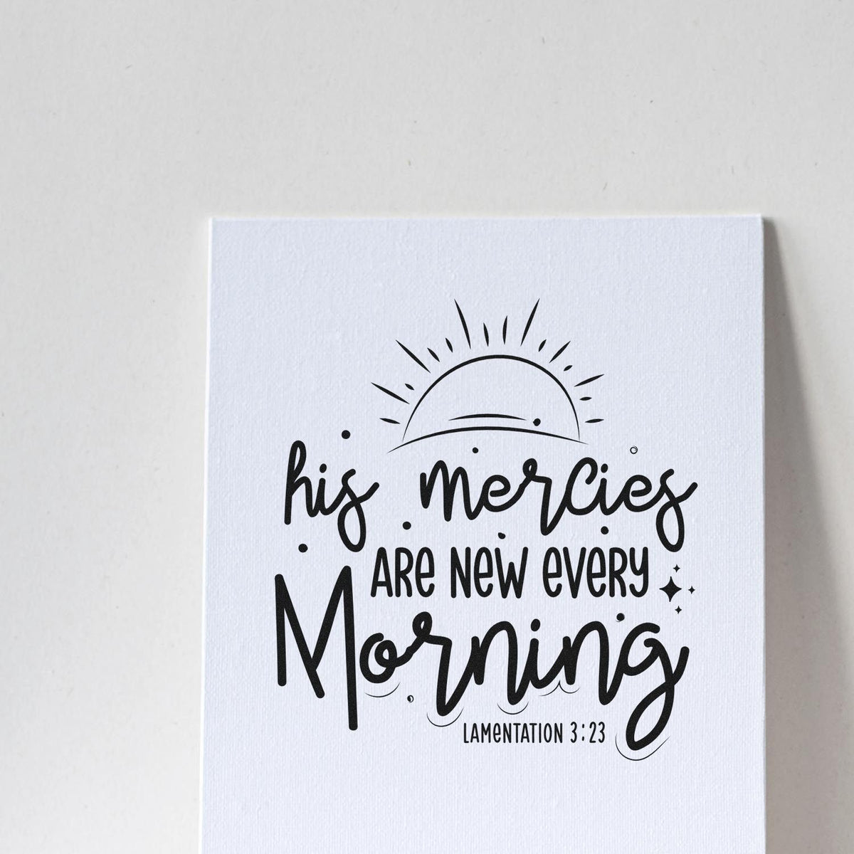 Black stamp seal with sunburst and hand-lettered quote, His mercies are new every morning, on white background.