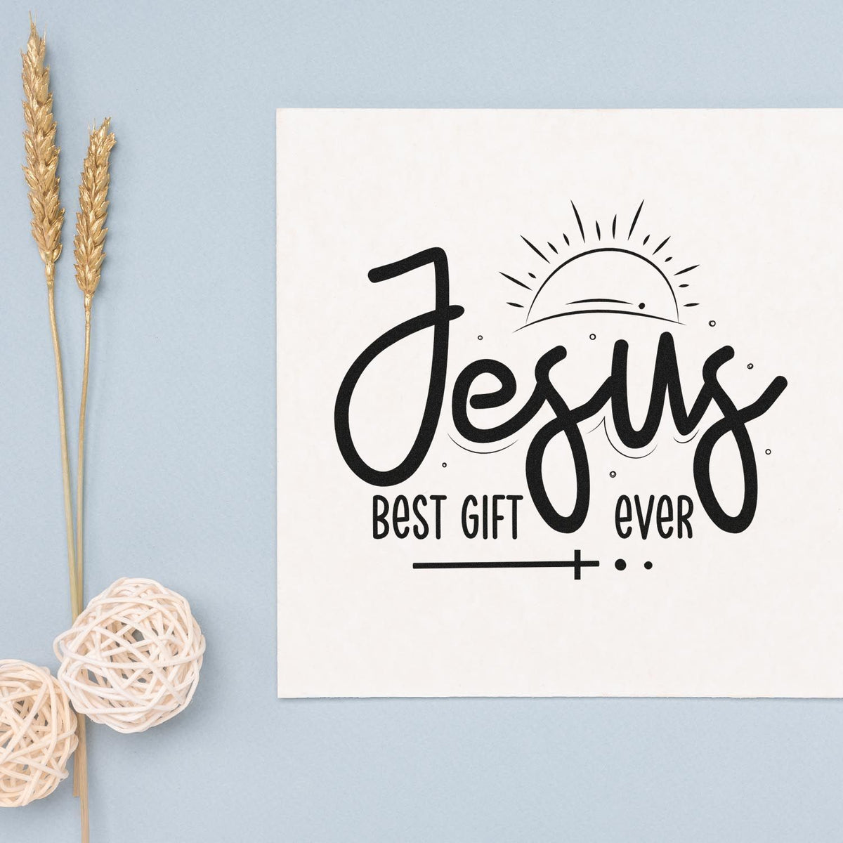 Black Jesus best gift ever stamp/seal design on white card with sunrise graphic, on pale blue background.