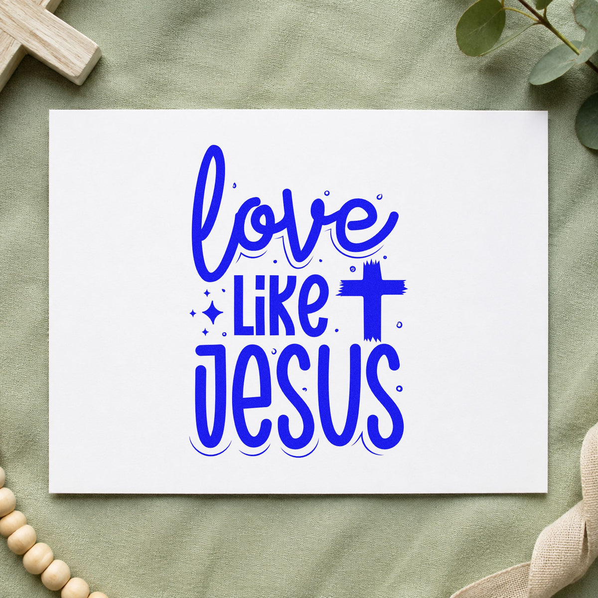 Love Like Jesus craft stamp imprinted in blue ink on paper, a design suited to volunteer tees.