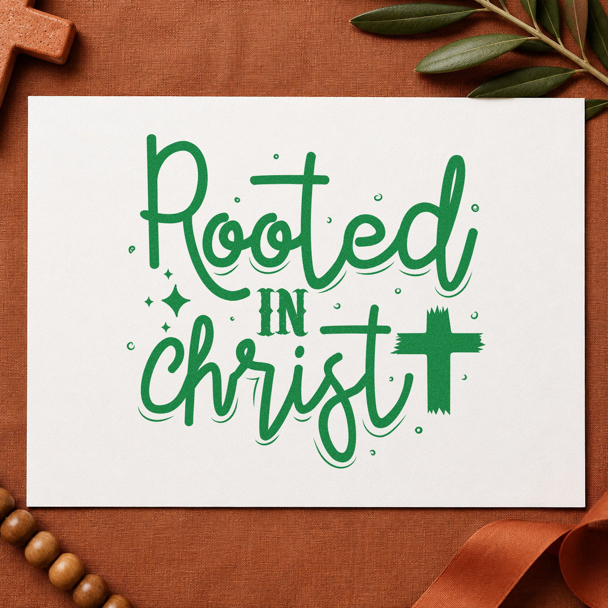 Rooted in Christ Script craft stamp imprint in green ink on a handmade project, one idea being garden marker labels.