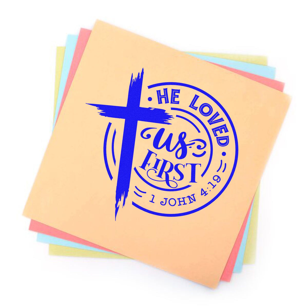 Pastel paper sheets featuring a blue Christian stamp seal with cross and He Loved Us First text.