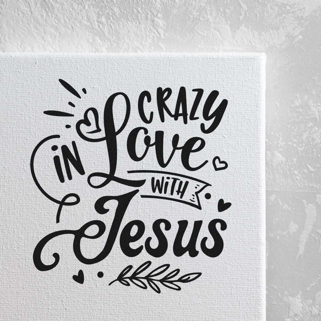 Black decorative stamp/seal design on white canvas reading Crazy in Love with Jesus, with hearts and leafy accents.