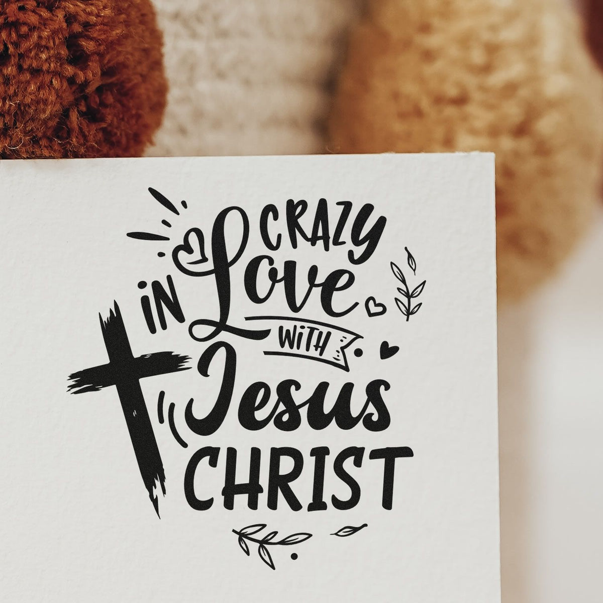 Black Christian stamp/seal on white paper with cross, hearts, and Crazy in Love with Jesus Christ lettering.