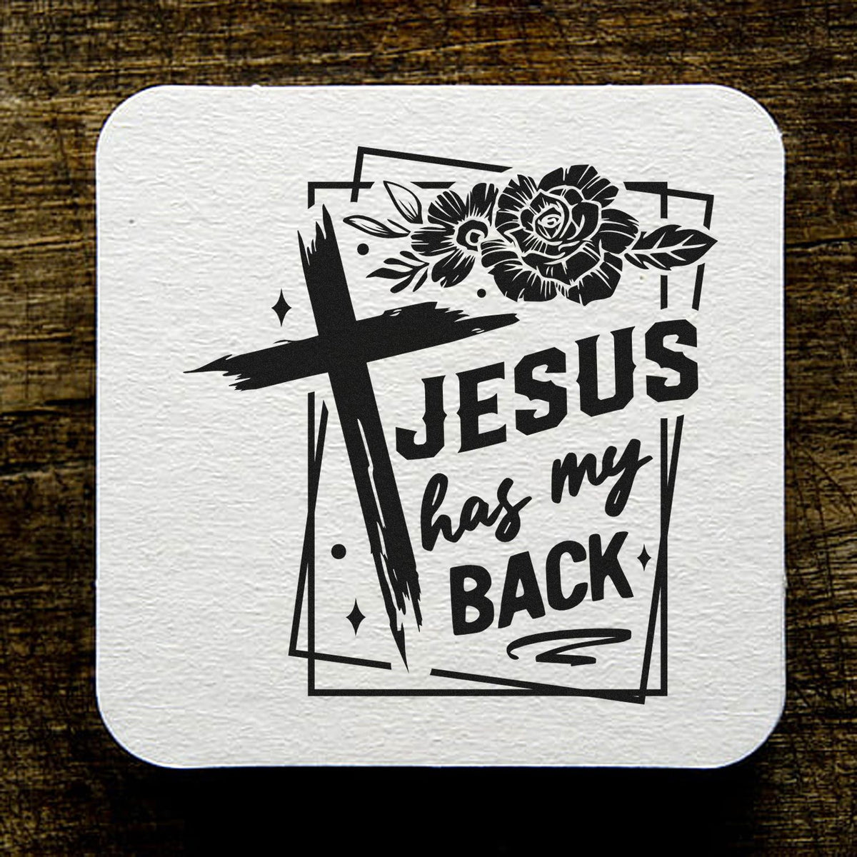 Black Jesus stamp and seal design with cross, flowers, and has my back text on a white textured square.