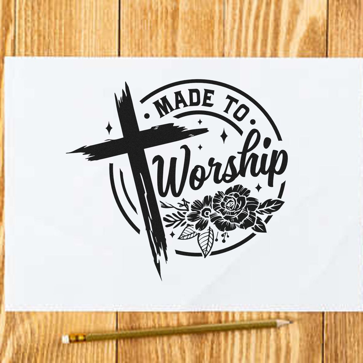 Black Made to Worship stamp and seal with cross, flowers, on white paper over wood.