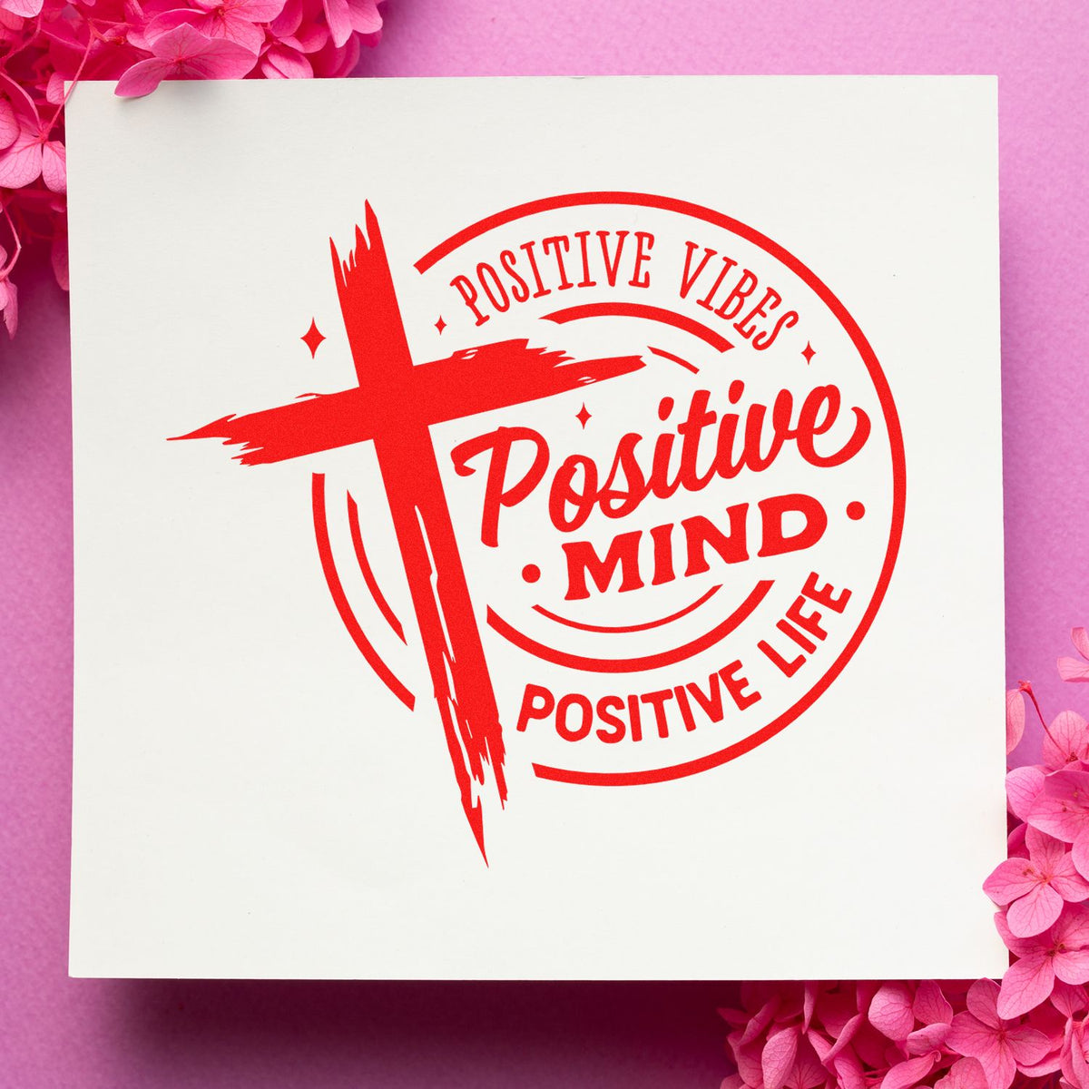 Red Positive Mind stamp and seal on white card, framed by pink flowers on a pink background.